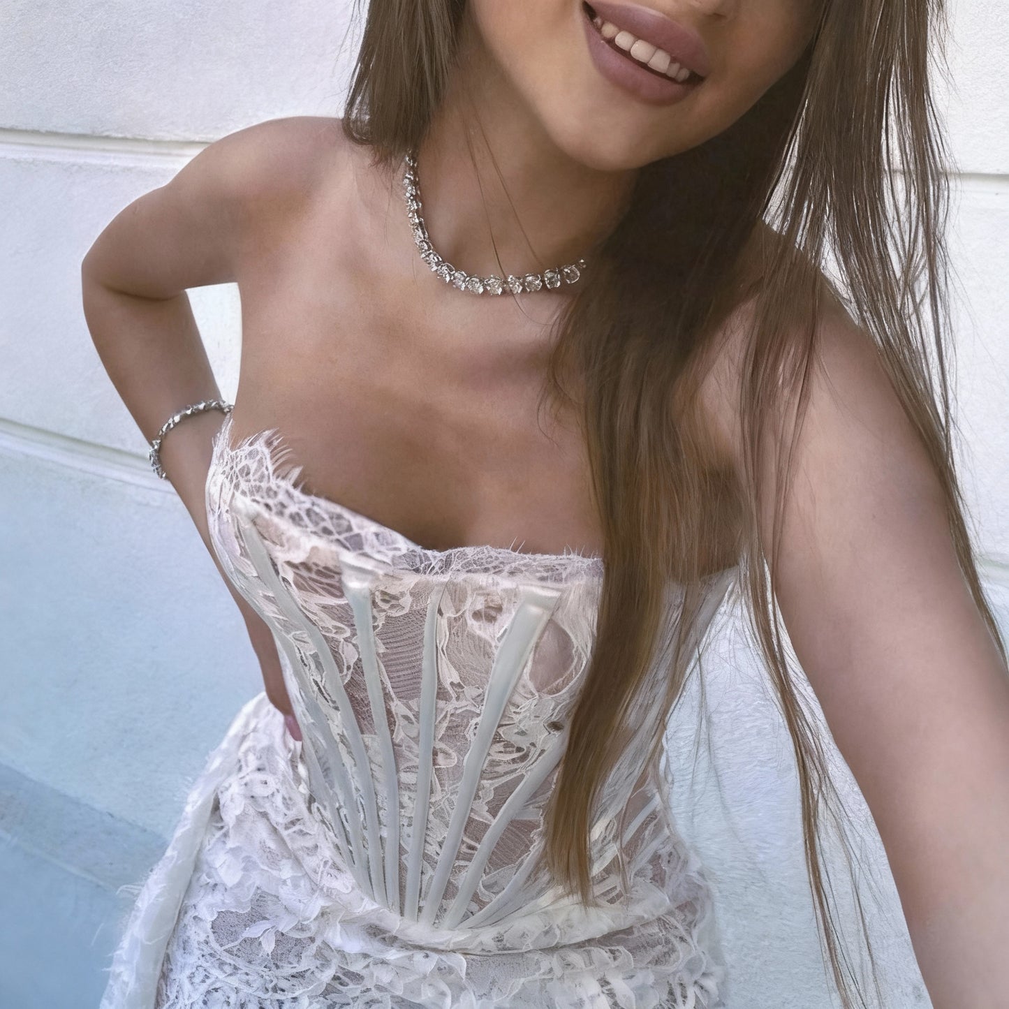 Woman wearing a white lace dress with a blurred background