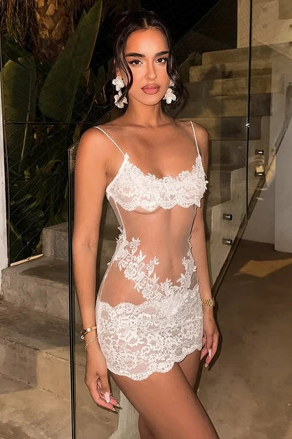 Woman wearing a white lace mini dress set outdoors.